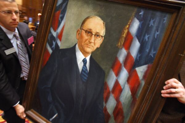 Timothy Frilingos of Georgia Capitol Museum prepares to place a portrait of late Speaker Tom Murphy outside the chamber on Wednesday. Murphy, the nation's longest serving speaker of the House, died in December 2007. (AJC)