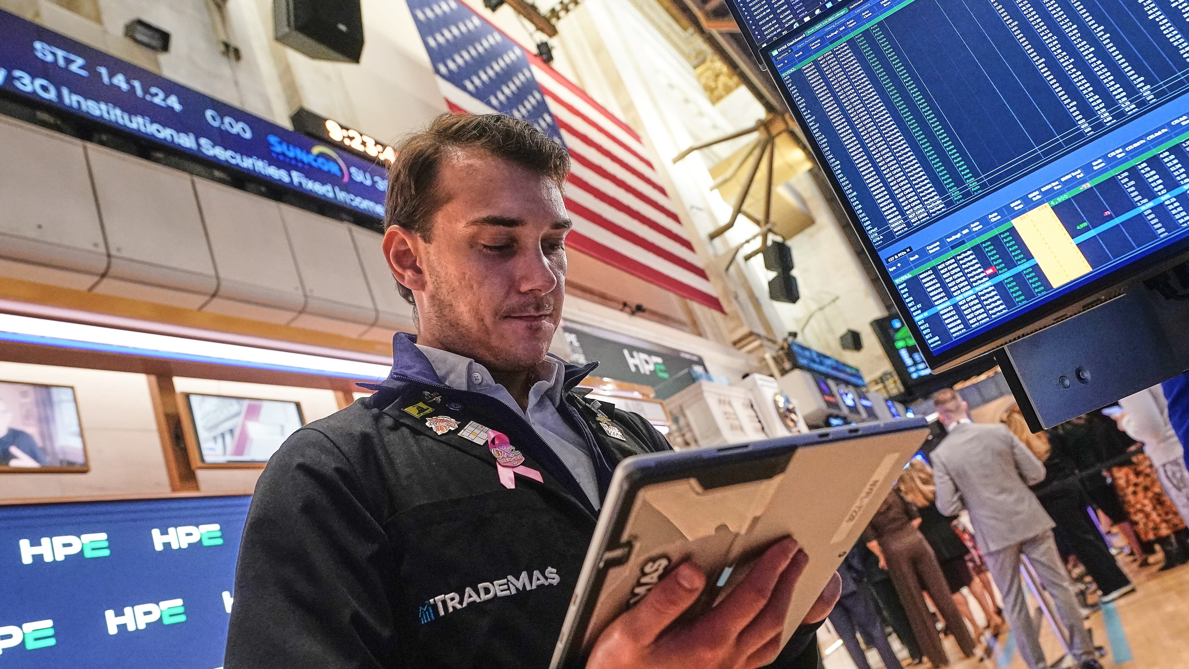 Trader Dylan Halvorsan works on the floor of the New York Stock Exchange, Wednesday, Oct. 15, 2025. (AP Photo/Richard Drew)