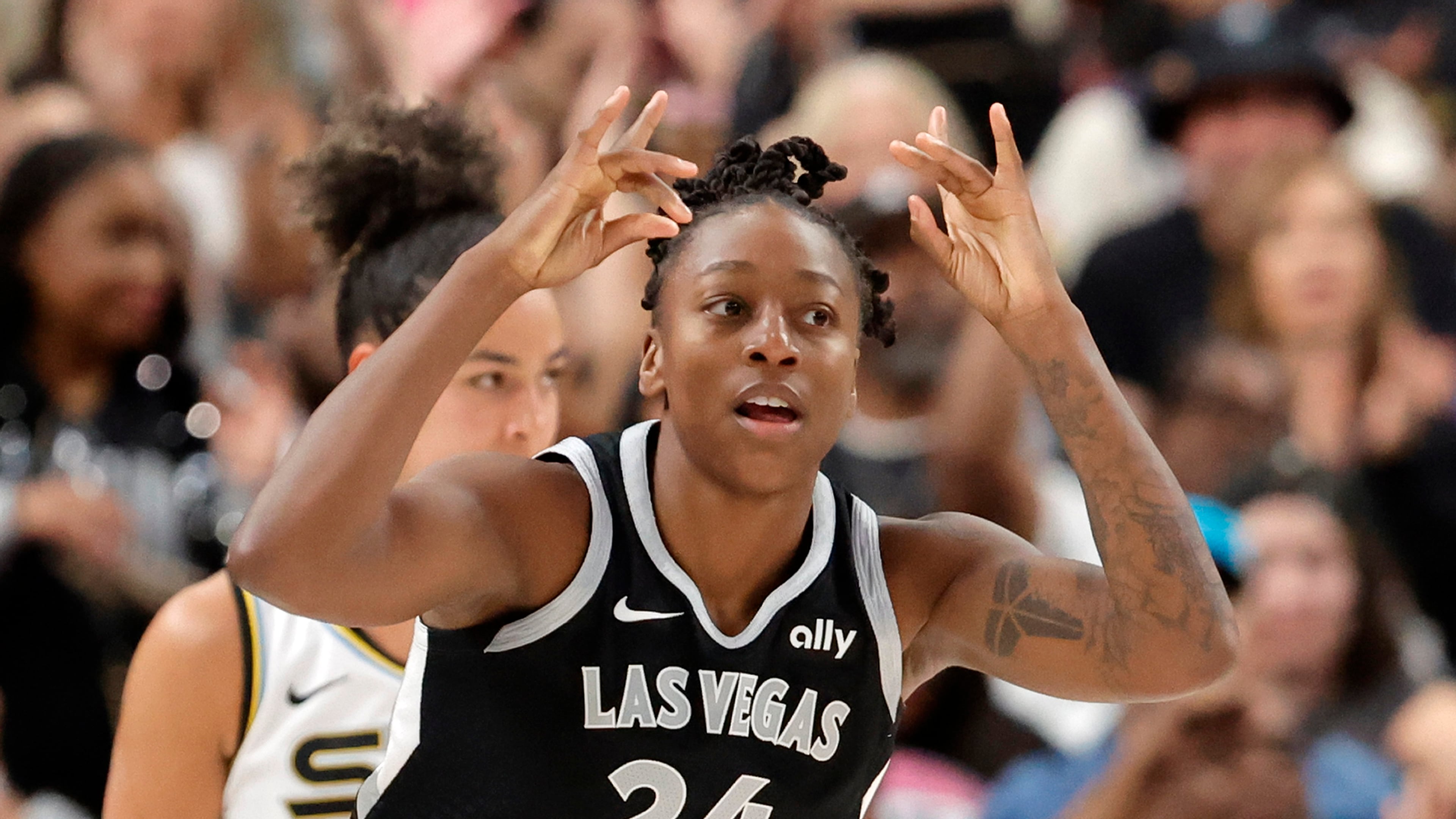 Las Vegas Aces guard Jewell Loyd (24) reacts after scoring a 3-point basket against the Chicago Sky during the second half of a WNBA basketball game Tuesday, Sept. 9, 2025, in Las Vegas. Loyd scored her 6,000th career point during the game. (Steve Marcus/Las Vegas Sun via AP)