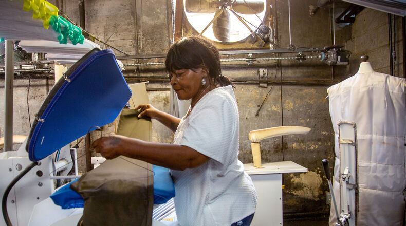 Elizabeth McGill presses a pair of pants while working at Sig Samuels Dry Cleaners in Atlanta. Dry cleaners across the nation have seen business plummet as American's adopted more relaxed attire while working from home and being under quarantines. STEVE SCHAEFER FOR THE ATLANTA JOURNAL-CONSTITUTION