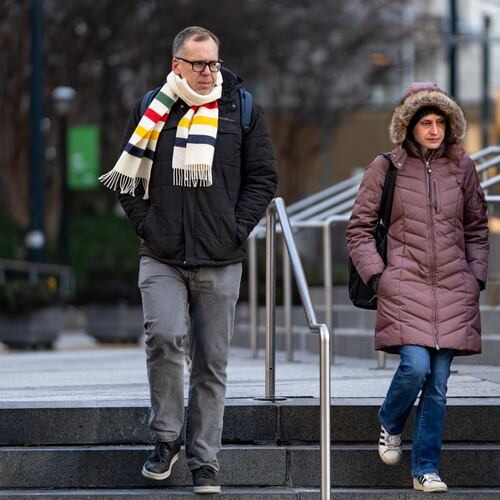A man and woman walk down Hurt Plaza during sub-freezing temperatures on Tuesday, Jan 27, 2026. Snow is possible this weekend, with the highest threat in eastern Georgia. (Ben Hendren for the AJC)