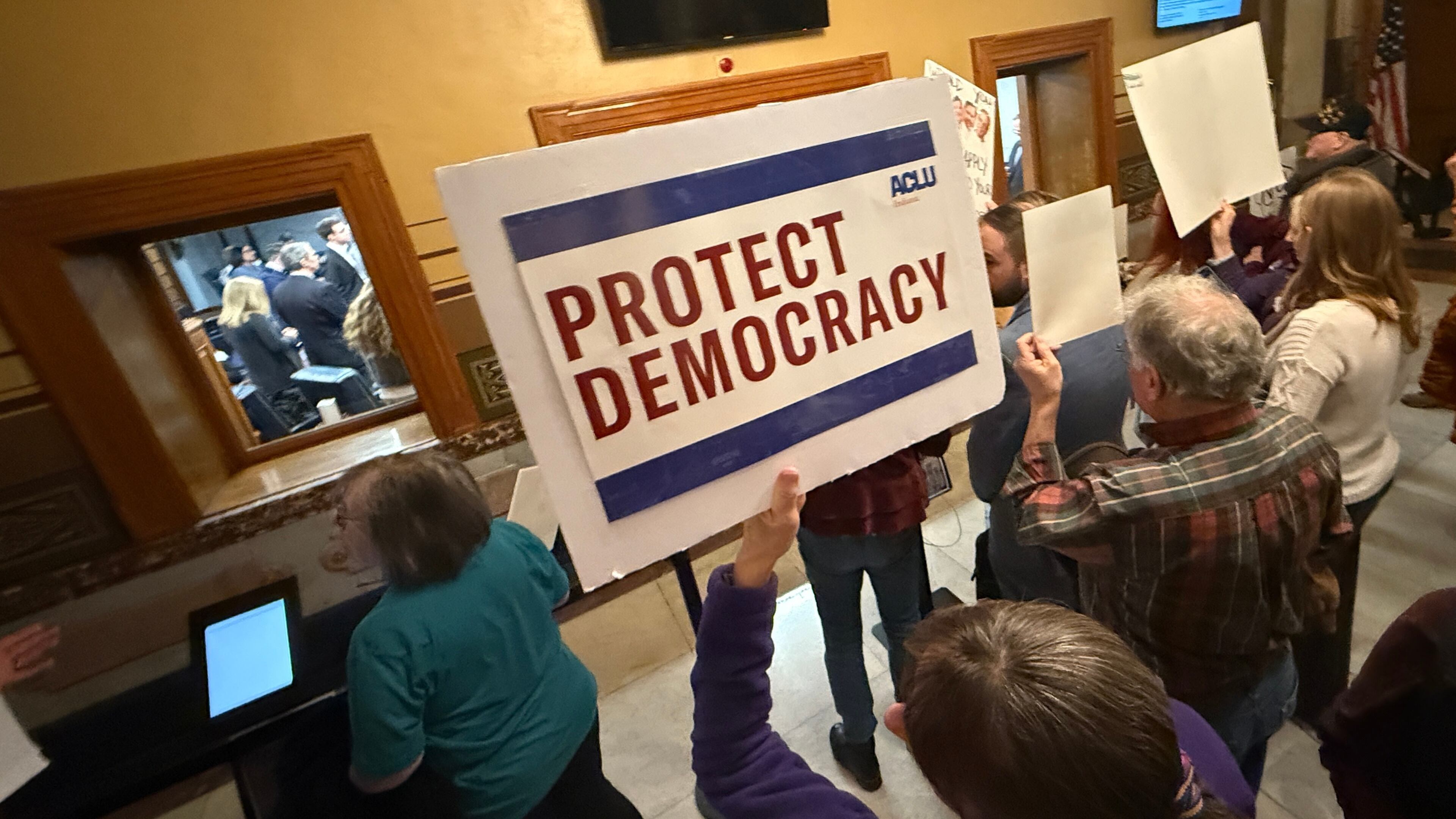 Protesters gather outside the Senate chamber at the Statehouse as senators meet during a special session to vote on a new congressional map Monday, Dec. 8, 2025, in Indianapolis. (AP Photo/Obed Lamy)
