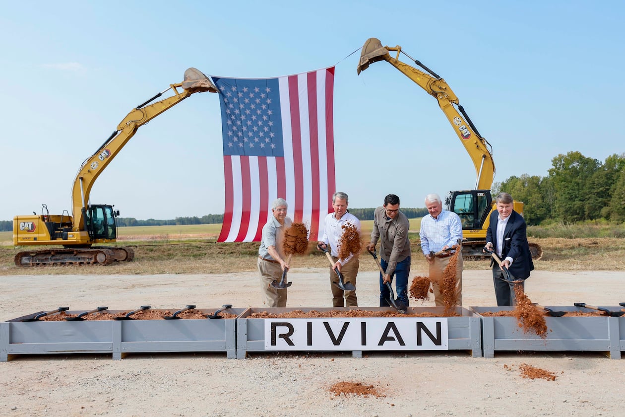 From left, Rivian CEO RJ Scaringe, Georgia Gov. Brian Kemp and Georgia House Speaker Jon Burns — along with a special guest — participate in the groundbreaking ceremony for a new EV factory on Tuesday, Sept. 16, 2025, in Rutledge. (Miguel Martinez/AJC)