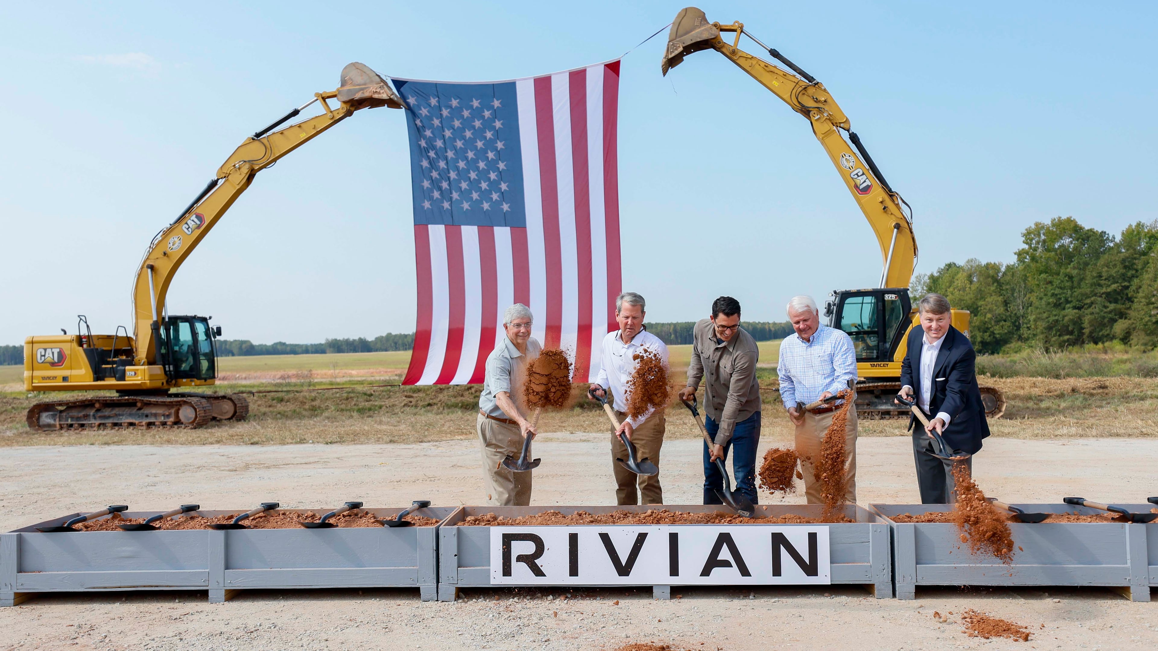 From left, Rivian CEO RJ Scaringe, Georgia Gov. Brian Kemp and Georgia House Speaker Jon Burns — along with a special guest — participate in the groundbreaking ceremony for a new EV factory on Tuesday, Sept. 16, 2025, in Rutledge. (Miguel Martinez/AJC)