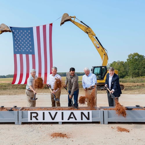 Georgia Gov. Brian Kemp (second from left), Rivian CEO RJ Scaringe (center) and Georgia House Speaker Jon Burns (second from right), along with special guests, participate in the Rivian groundbreaking ceremony on Tuesday, Sept. 16, 2025, in Walton and Morgan counties. (Miguel Martinez/AJC)