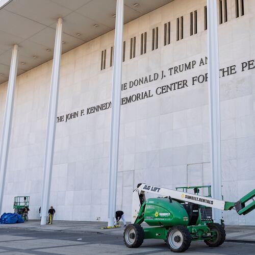 FILE - Workers add President Donald Trump's name to the John F. Kennedy Memorial Center for the Performing Arts, after a Trump-appointed board voted to rename the institution, in Washington, Dec. 19, 2025. (AP Photo/J. Scott Applewhite, File)