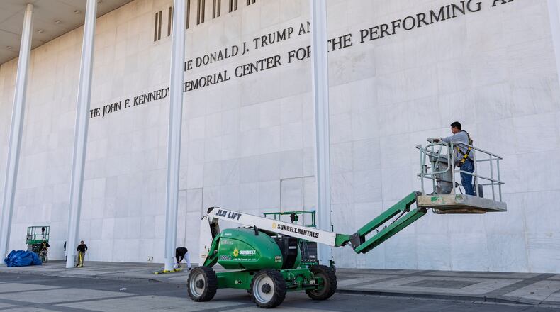 FILE - Workers add President Donald Trump's name to the John F. Kennedy Memorial Center for the Performing Arts, after a Trump-appointed board voted to rename the institution, in Washington, Dec. 19, 2025. (AP Photo/J. Scott Applewhite, File)