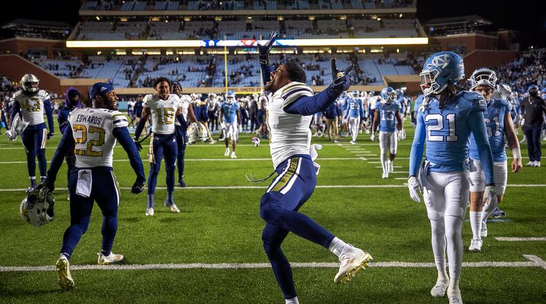 Georgia Tech's Myles Sims, center, celebrates the team's 21-17 victory over North Carolina in an NCAA college football game, Saturday, Nov. 19, 2022, at Kenan Stadium in Chapel Hill, N.C. (Robert Willett/The News & Observer via AP)