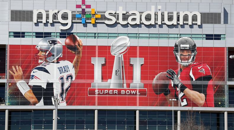 A giant Matt Ryan and Tom Brady centerpiece the main entrance to NRG Stadium, site of the Super Bowl, on Monday, Jan. 30, 2017, in Houston