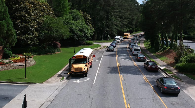 May 23, 2018 Sandy Springs - A Fulton County Schools bus brings traffic to a halt on Powers Ferry Road in Sandy Springs, in the last week of school. HYOSUB SHIN / HSHIN@AJC.COM