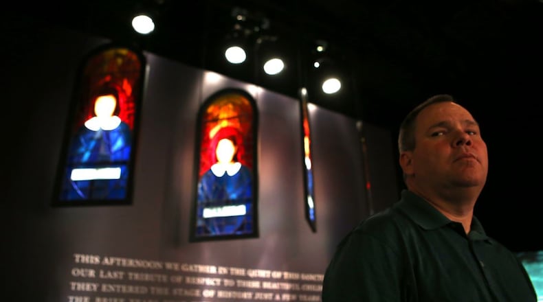 Gwinnett County Commissioner Tommy Hunter, seen here with a memorial to the four girls killed in a 1963 church bombing in Birmingham, Alabama, and his colleagues on the Board of Commissioners visited the National Center for Civil and Human Rights on Tuesday. Hunter recently called civil rights leader John Lewis a “racist pig.” HENRY TAYLOR / HENRY.TAYLOR@AJC.COM