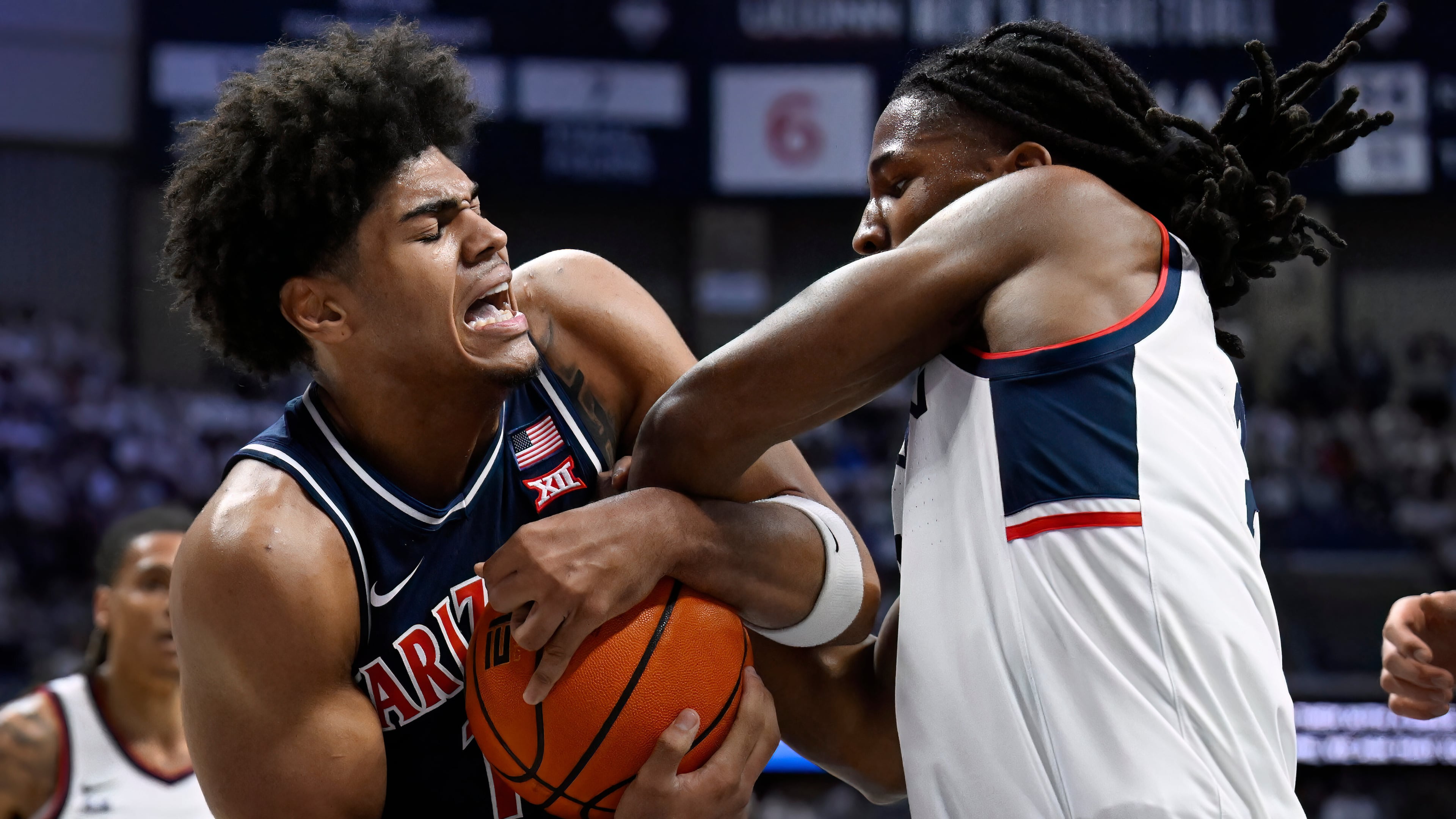 Arizona forward Koa Peat and UConn guard Silas Demary Jr., right, fight for possession of the ball in the first half of an NCAA college basketball game, Wednesday, Nov. 19, 2025, in Storrs, Conn. (AP Photo/Jessica Hill)