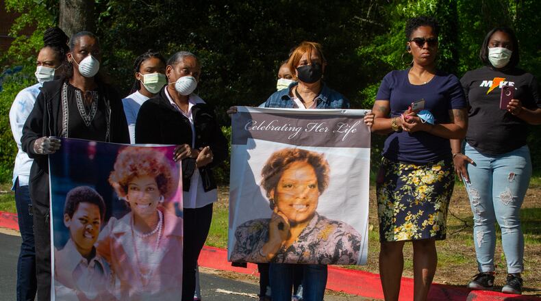 Family members hold photographs of Nancy Finney, who they say died of COVID-19 while living at Arbor Terrace at Cascade retirement community at a recent press conference. The assisted living facility in Atlanta has been one of the hardest hit senior care homes in Georgia with 15 deaths registered. STEVE SCHAEFER / SPECIAL TO THE AJC