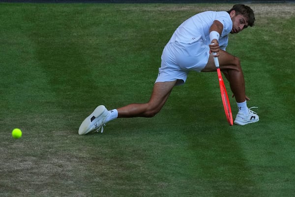 Italy's Flavio Cobolli returns to Serbia's Novak Djokovic during a quarterfinal men's singles match at the Wimbledon Tennis Championships in London, Wednesday, July 9, 2025. (AP Photo/Joanna Chan)