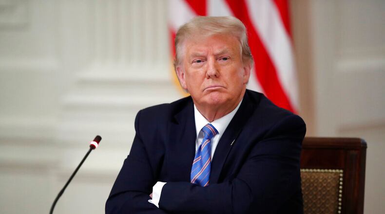 President Donald Trump listens during a "National Dialogue on Safely Reopening America's Schools," event in the East Room of the White House, Tuesday, July 7, 2020, in Washington. (AP Photo/Alex Brandon)