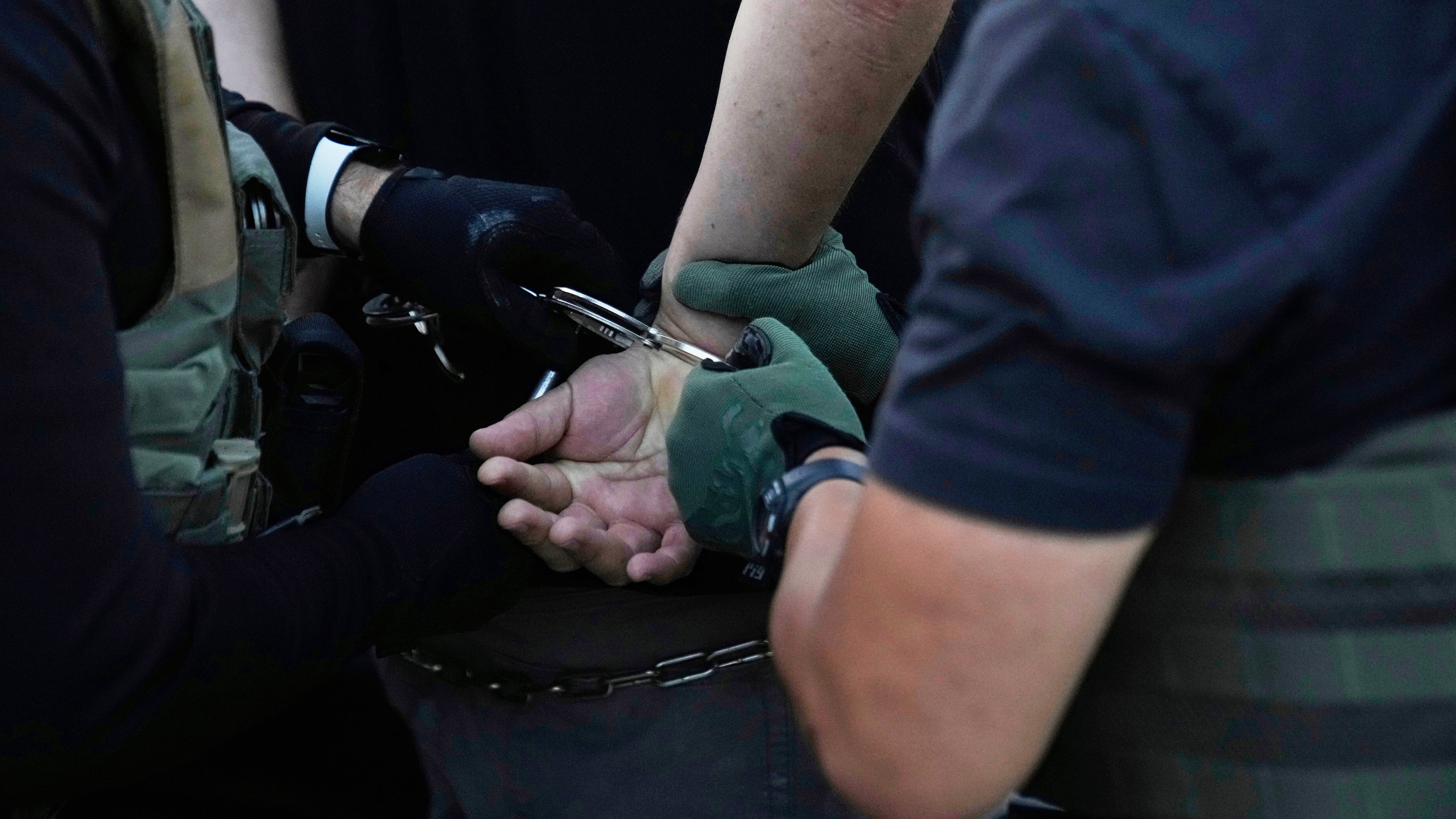 FILE - U.S. Immigration and Customs Enforcement agents make an arrest during an early morning operation in Park Ridge, Ill., Sept. 19, 2025. (AP Photo/Erin Hooley, File)