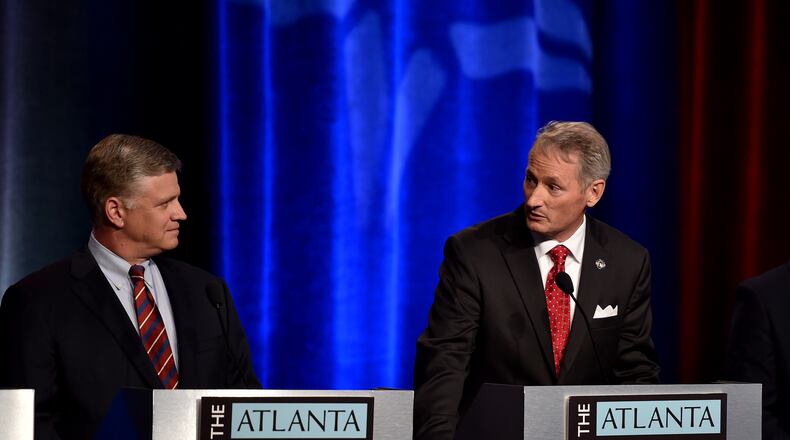 Mike Crane, center, answers a question during the Atlanta Press Club debate series in Atlanta while Drew Ferguson looks on. BRANT SANDERLIN/BSANDERLIN@AJC.COM