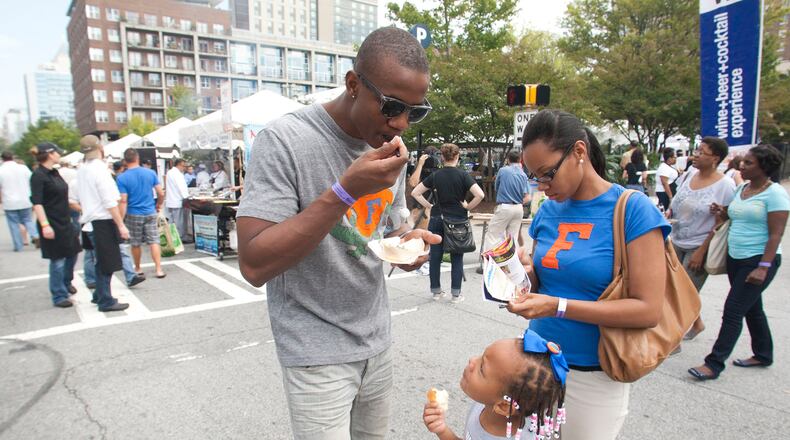 Maurio Andrews enjoys Taste of Atlanta 2012 with his wife Ashley and daughter Ava. (AJC File Photo)
