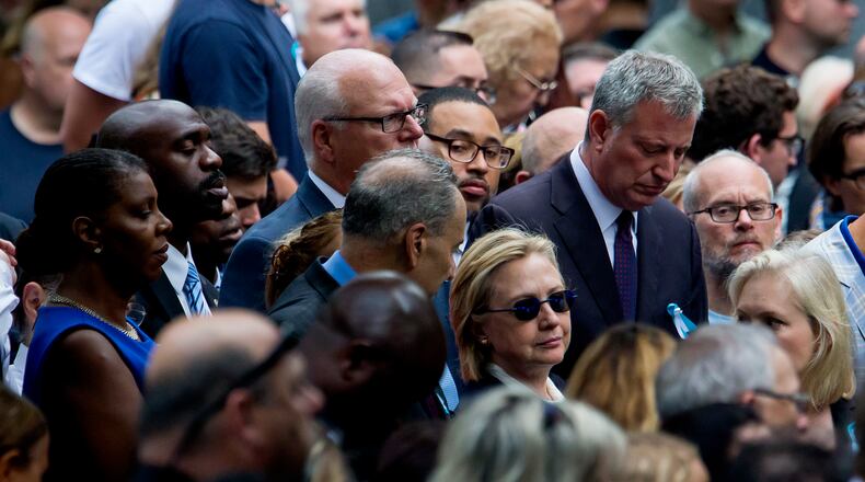 Hillary Clinton is flanked by Sen. Chuck Schumer (D-N.Y.), left, and Mayor Bill de Blasio during a ceremony to mark the 15th anniversary of the 9/11 attacks in lower Manhattan on Sunday, Sept. 11, 2016. (Eric Thayer/The New York Times)