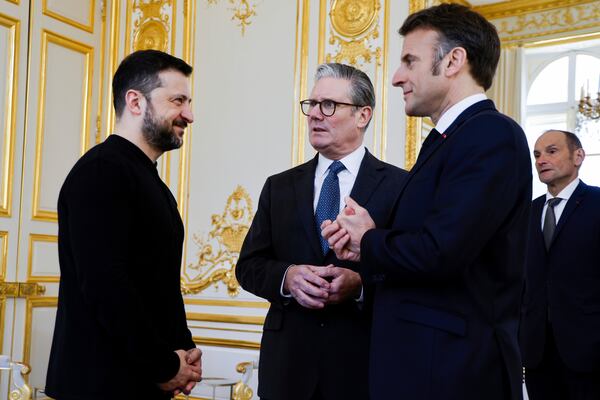 Ukraine's President Volodymyr Zelenskyy, left, French President Emmanuel Macron, right, and Britain's Prime Minister Keir Starmer speak during a trilateral meeting on the sidelines of a summit for "coalition of the willing" at the Elysee Palace, Thursday, March 27, 2025. (Ludovic Marin, Pool via AP)