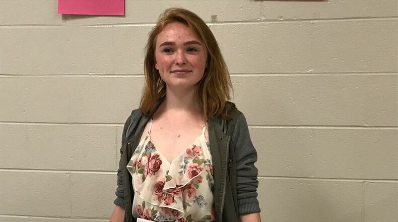 Megan Hawes, a senior at Gwinnett County's Brookwood High School, wrote cards and letters congratulating each member of the class of 2017. Hawes is standing behind envelopes with some of the notes. ERIC STIRGUS / ESTIRGUS@AJC.COM