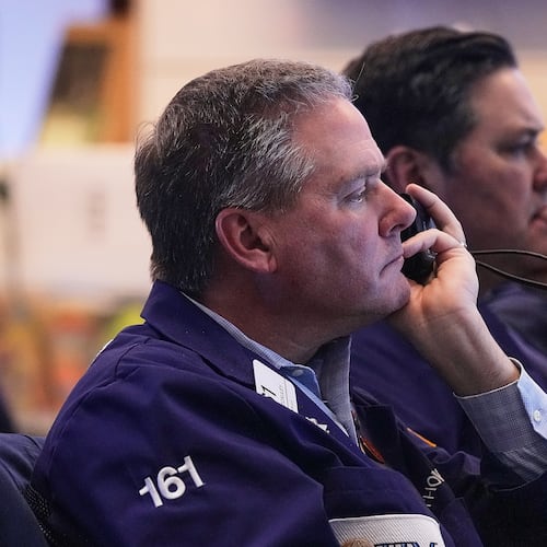 Trader Thomas McCauley, foreground, and a colleague work on the floor of the New York Stock Exchange, Friday, Jan. 2, 2026. (AP Photo/Richard Drew)