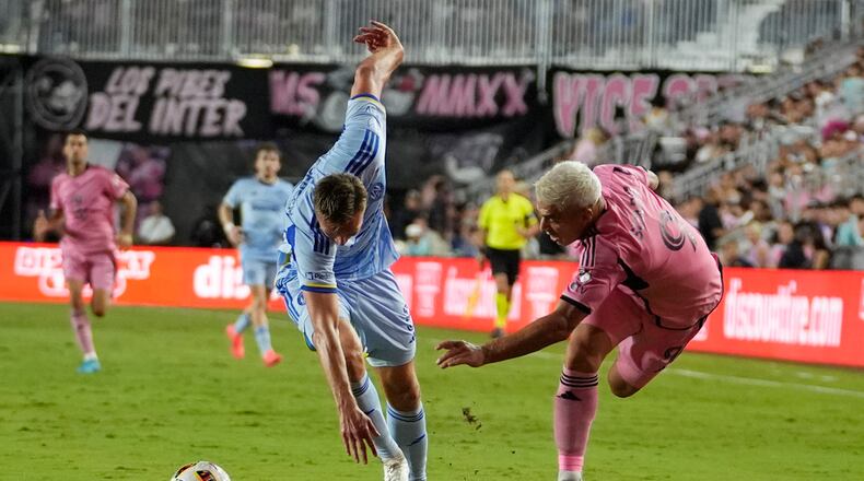 Atlanta United defender Stian Gregersen (5) and Inter Miami forward Luis Suárez (9) collide as they run for the ball during the first half of match one of their MLS playoff opening round soccer match, Friday, Oct. 25, 2024, in Fort Lauderdale, Fla. (AP Photo/Lynne Sladky)