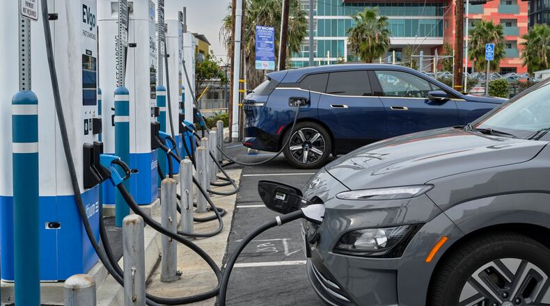An electric vehicle charging station in a parking lot in Santa Monica, Calif. Electric vehicles will get even more expensive, but prices for Teslas and some other models may not rise as much as prices for some conventional cars. (Philip Cheung/The New York Times file)