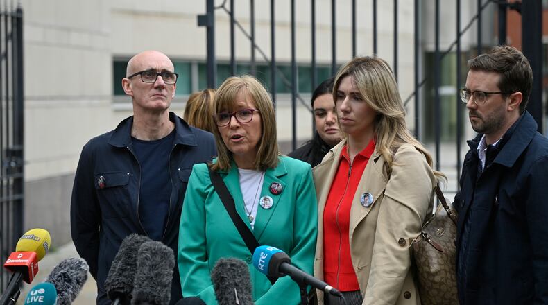 Lyra McKee's sister Nichola Corner, center, speaks to the media outside Belfast Crown Court in Belfast, Ireland, where Paul McIntyre, Peter Cavanagh and Jordan Gareth Devine have been found not guilty in a non-jury trial of the murder of journalist Lyra McKee, Friday July 3, 2026. (PA via AP)