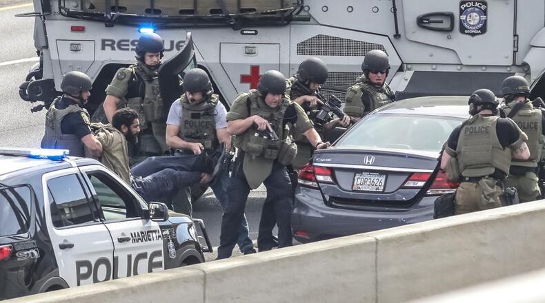 Nearly six months after a man suspected of robbing a Marietta Walmart was involved in an hourslong police standoff on the side of I-75, he has been cleared in the robbery.