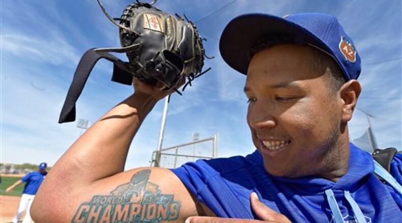 FILE - In this Tuesday, March 1, 2016, file photo, Kansas City Royals' Salvador Perez shows his new World Series Championship tattoo following spring baseball practice in Surprise, Ariz. In a move that Perez�s agent, Rick Thurman, said he had never experienced in all his years in baseball, the Royals gave their three-time Gold Glove winner a $52.5 million, five-year contract that was tacked onto this year, effectively replacing a laughable $7 million, five-year deal from 2012 that included three years of budget-friendly options. (John Sleezer/The Kansas City Star via AP, File) MANDATORY CREDIT
