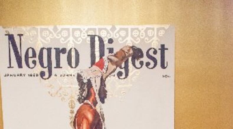 Fahamu Pecou stands in the High Museum of Art gallery where his Imagining New Worlds" exhibit is on view. It's the Atlanta artist's first solo show at the High. CONTRIBUTED BY GANNON