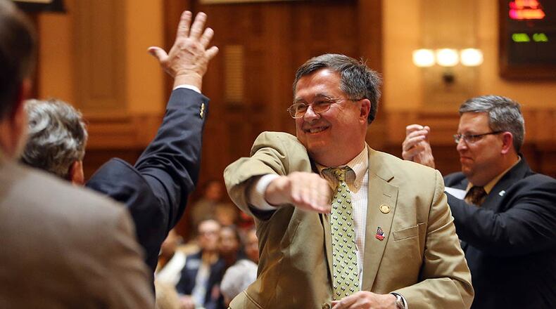 Rep. Rick Jasperse (R-Jasper) celebrates after his gun bill received final passage in the House after 11 p.m. on the last day of the session Thursday evening, March 20, 2014.