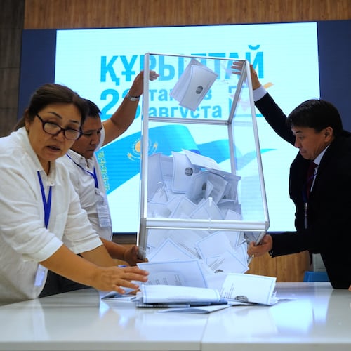Election commission members count ballots at a polling station during early parliamentary elections in Almaty, Kazakhstan, Sunday, Aug. 23, 2026. (AP Photo/Vladimir Tretyakov)
