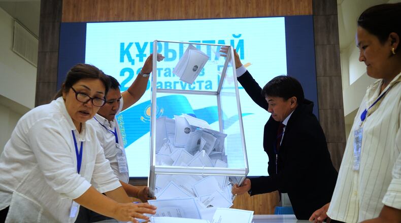 Election commission members count ballots at a polling station during early parliamentary elections in Almaty, Kazakhstan, Sunday, Aug. 23, 2026. (AP Photo/Vladimir Tretyakov)