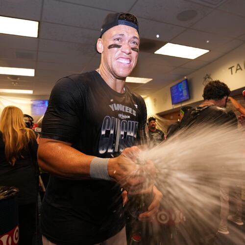 New York Yankees' Aaron Judge celebrates with teammates after they clinched the playoffs in a baseball game against the Minnesota Twins, Monday, Sept. 14, 2026, in Minneapolis. (AP Photo/Abbie Parr)
