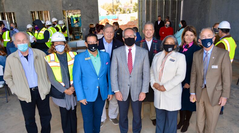 Photo L - R: Randy Foster, Aurora Theatre Board; Ann-Carol Pence, Aurora Theatre; Anthony Rodriguez, Aurora Theatre; Councilman Bob Clarke; Mayor David Still; Chuck Warbington, City Manager; Councilwoman Victoria Jones; Lee Merritt, Downtown Development Authority; and Councilman Glenn Martin gather to celebrate placement of the final beam at the Lawrenceville Performing Arts Center. (Courtesy City of Lawrenceville)