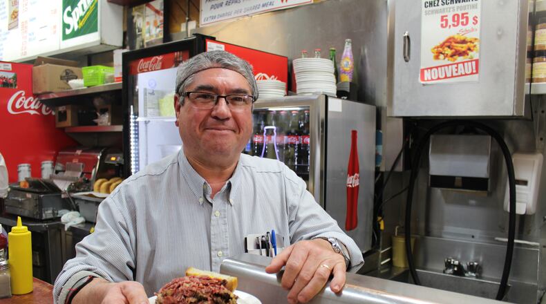 Joao Goncalves serves up one of Schwartz's legendary smoked meat sandwiches -- a half, actually -- just as servers have done here since 1928. (Alan Solomon/Chicago Tribune/TNS)