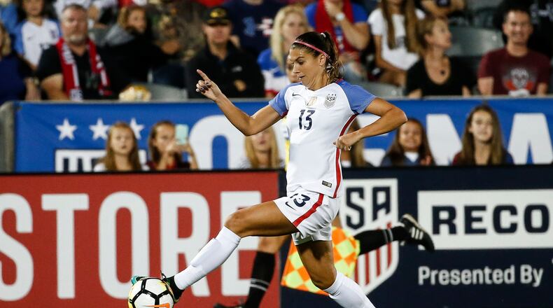 In this Sept. 15, 2017 photo, U.S. forward Alex Morgan (13) moves the ball against New Zealand during the first half of an international friendly soccer match in Commerce City, Colo. The U.S. Women's National Team Players Association is donating $16,000 to help get the union for players in the National Women's Soccer League off the ground. The NWSL Players Association represents more than 160 players who are not paid by the U.S. and Canadian soccer federations. Those federations pay the salaries of several national team players who are allocated across the five-year-old women's professional league.(AP Photo/Jack Dempsey)