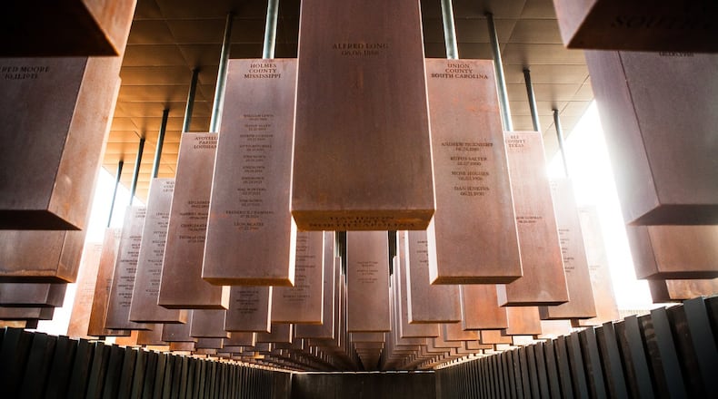 Hanging steel monuments dangle like bodies above visitors at the National Memorial for Peace and Justice in Montgomery, Ala. The names of lynching victims are inscribed on the monuments, each representing a county in the United States where a lynching occurred. (Contributed by Equal Justice Initiative)