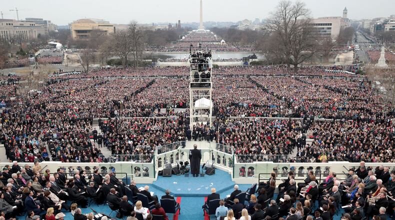 WASHINGTON, DC - JANUARY 20: Spectators watch the inauguration proceedings on the West Front of the U.S. Capitol on January 20, 2017 in Washington, DC. In today's inauguration ceremony Donald J. Trump becomes the 45th president of the United States.