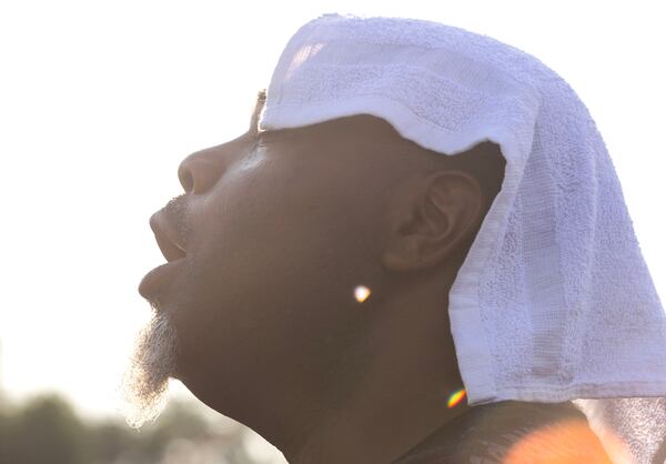 Derrick Brown cools off from the heat during Wind Down Concert in East Point on Wed., July 26, 2023. (Michael Blackshire/Michael.blackshire@ajc.com)