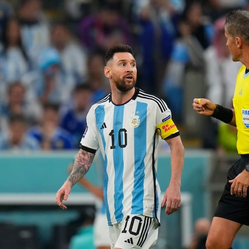 FILE - Referee Daniele Orsato talks to Argentina's Lionel Messi, left, during the World Cup semifinal soccer match between Argentina and Croatia at the Lusail Stadium in Lusail, Qatar, Dec. 13, 2022. (AP Photo/Petr David Josek, file)