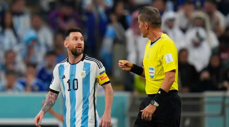 FILE - Referee Daniele Orsato talks to Argentina's Lionel Messi, left, during the World Cup semifinal soccer match between Argentina and Croatia at the Lusail Stadium in Lusail, Qatar, Dec. 13, 2022. (AP Photo/Petr David Josek, file)