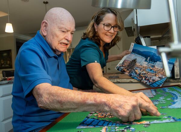 Beth Wilson (right) helps Bill Renner with a puzzle in his Gainesville home. Wilson is a caregiver with Seniors Helping Seniors of Hall, Forsyth, and Barrow Counties. PHIL SKINNER FOR THE ATLANTA JOURNAL-CONSTITUTION