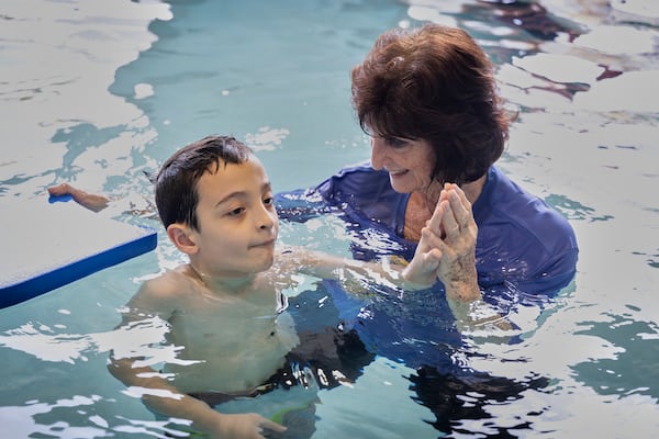 In this handout photo provided by Children's Services Council of Palm Beach County, instructor Dottie Diedrick guides a student in the water during an autism-specific swim class at Small Fish Big Fish, in West Palm Beach, Fla., Tuesday, April 1, 2025. (Ben Rusnak /Children's Services Council of Palm Beach County via AP)