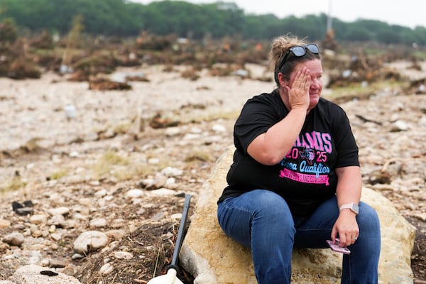 Marissa Zachry takes a moment while searching for survivors along the Guadalupe River on Sunday, July 6, 2025, in Hunt, Texas. (Jason Fochtman/Houston Chronicle via AP)