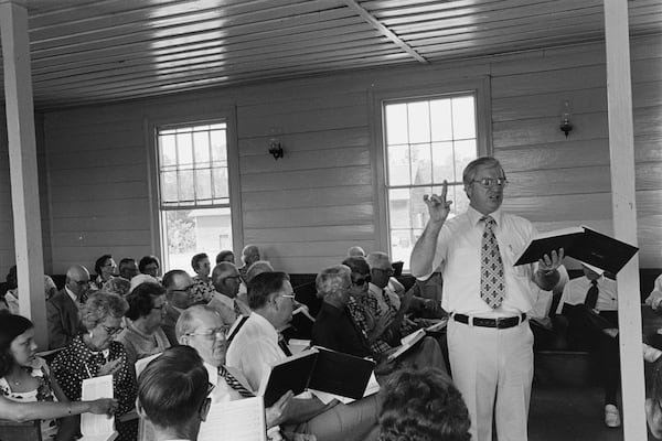 In this photo provided by the Library of Congress, Hugh McGraw leads singers at the South Georgia Sacred Harp Singing Convention in Tifton, Ga., on May 1, 1977. (Howard W. Marshall/Library of Congress via AP)