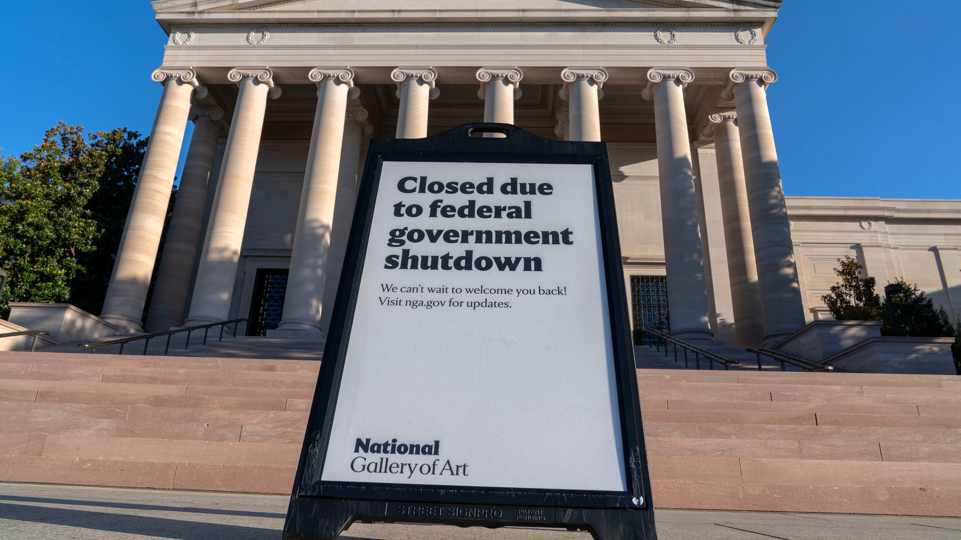 FILE - A sign that reads "Closed due to federal government shutdown," is seen outside of the National Gallery of Art in Washington, Oct. 6, 2025. (AP Photo/Jose Luis Magana, File)