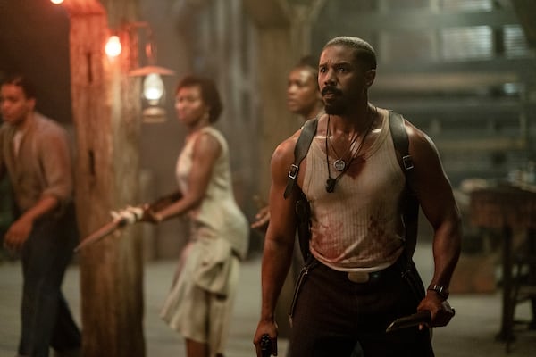 This image released by Warner Bros Pictures shows Michael B. Jordan, right, in a scene from "Sinners." (Warner Bros. Pictures via AP)